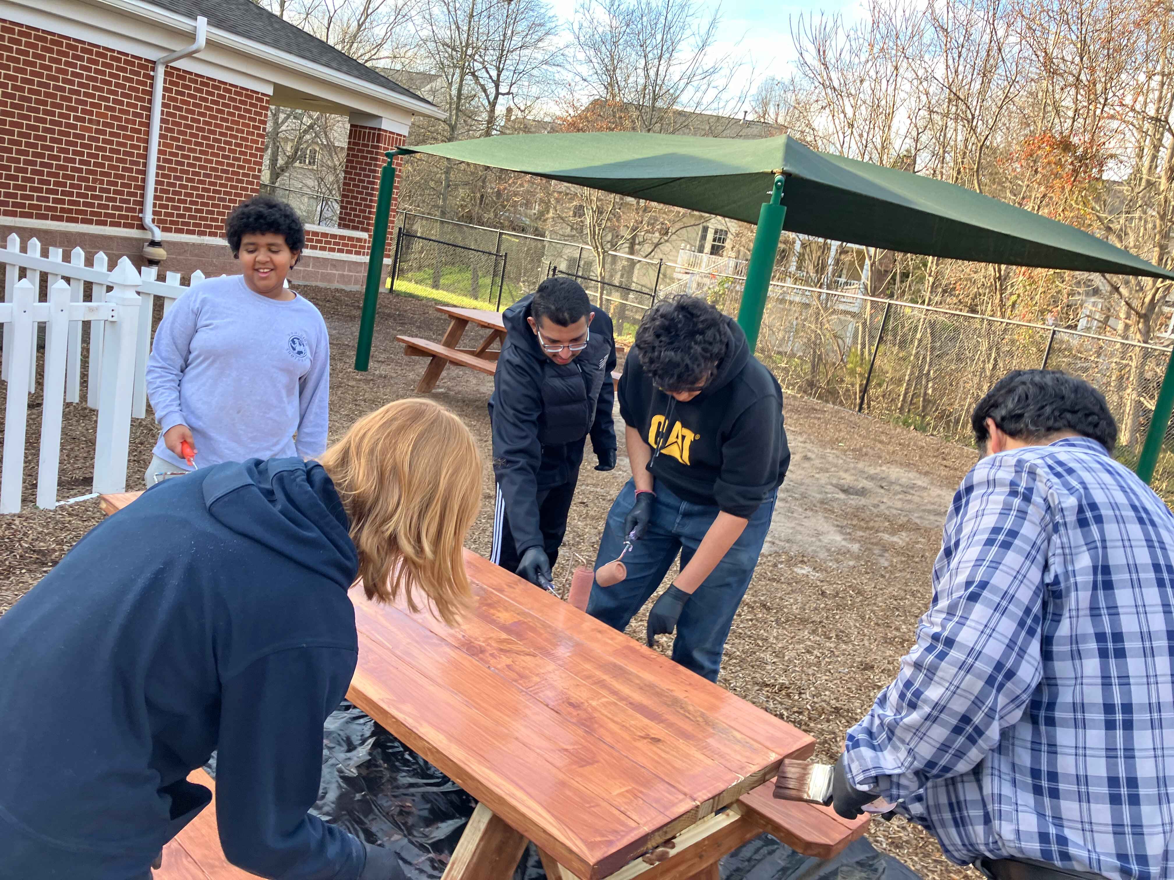 Volunteers almost finished painting a table